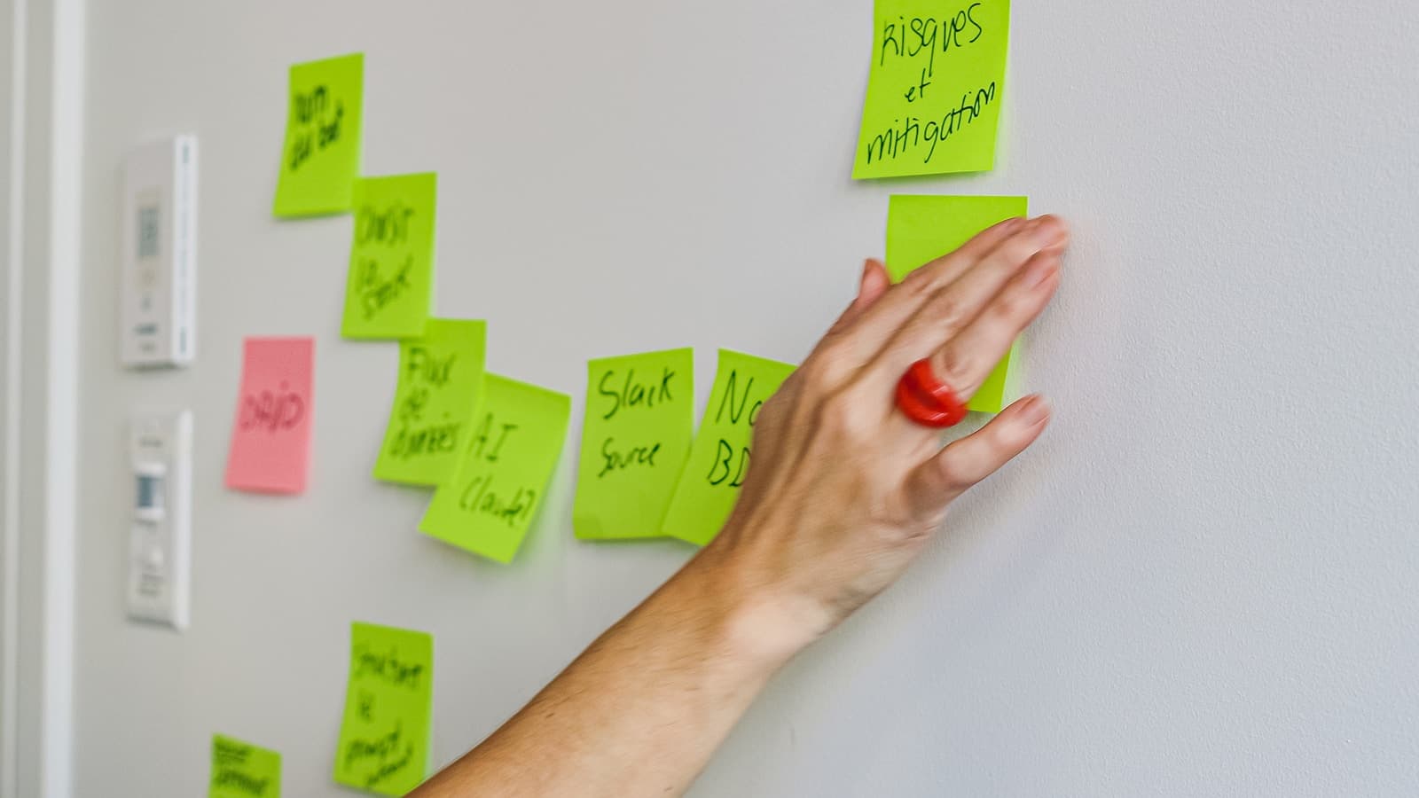 A planning workshop organized around a wall of notes