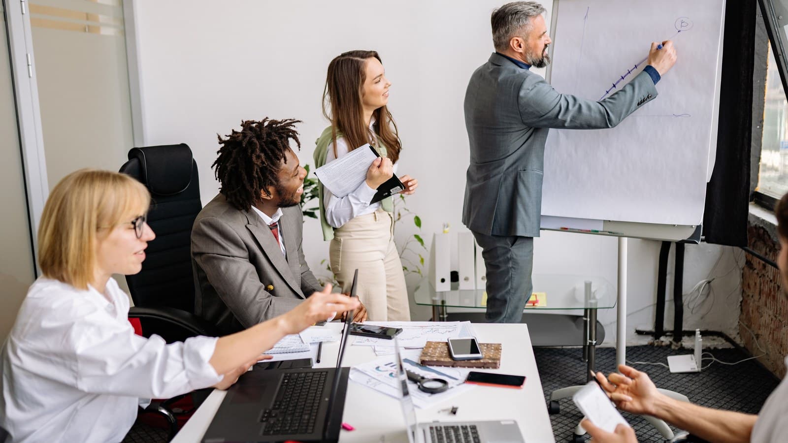 Colleagues work through a presentation together in a meeting